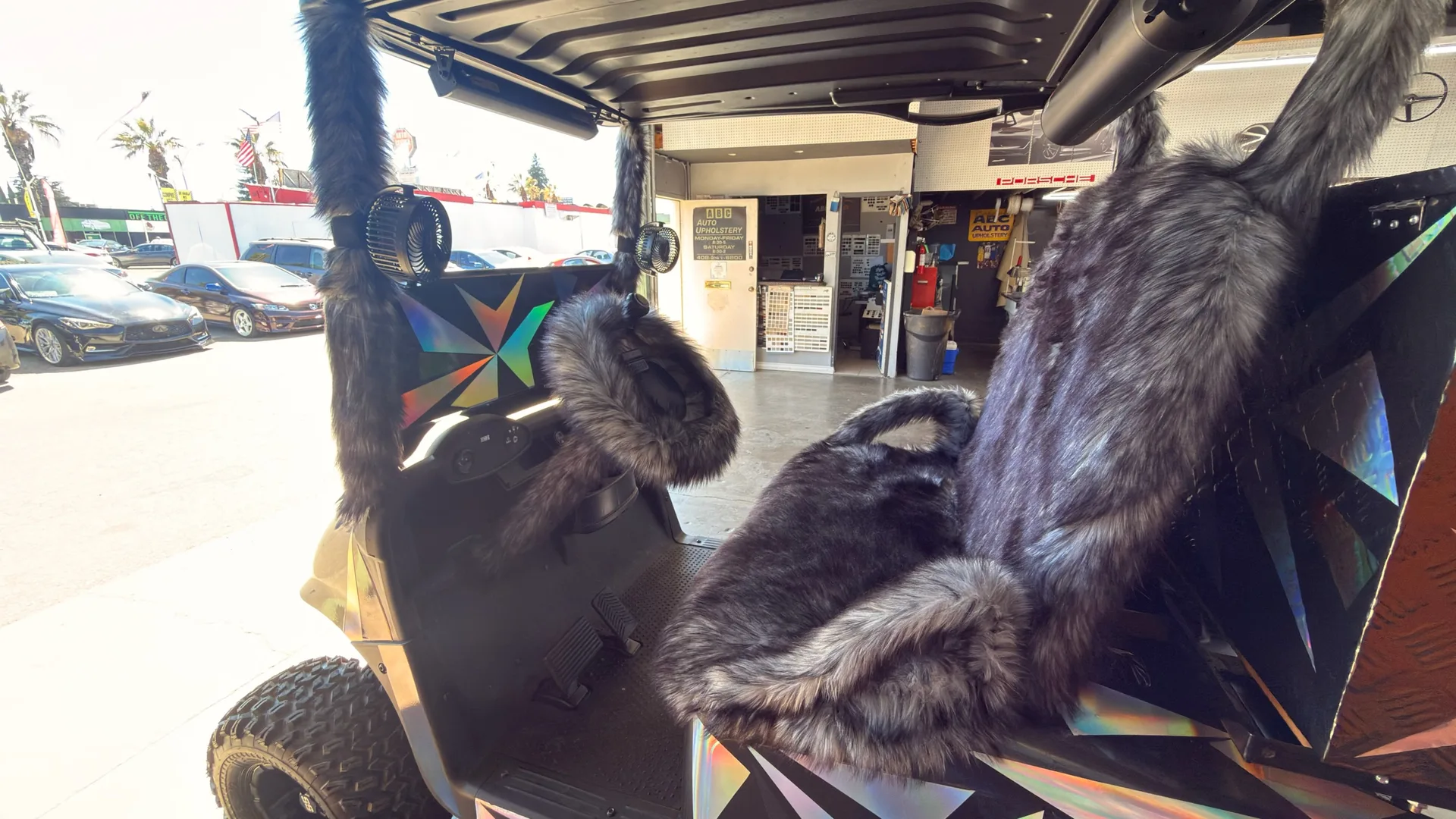 Finished golf cart interior with a gray fur-textured steering wheel, matching column, seats and high backrest at ABC's San Jose shop.